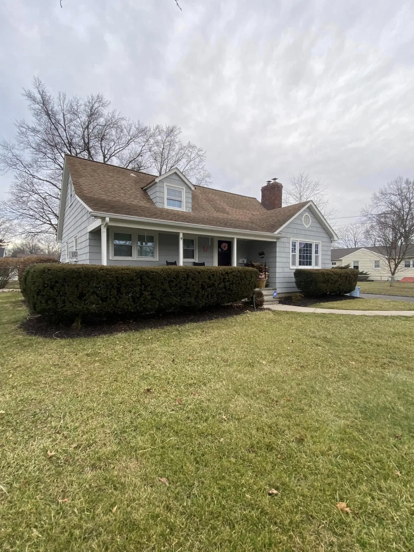 Front yard with trimmed hedges and clean mulch beds by Fiorenza Landscaping