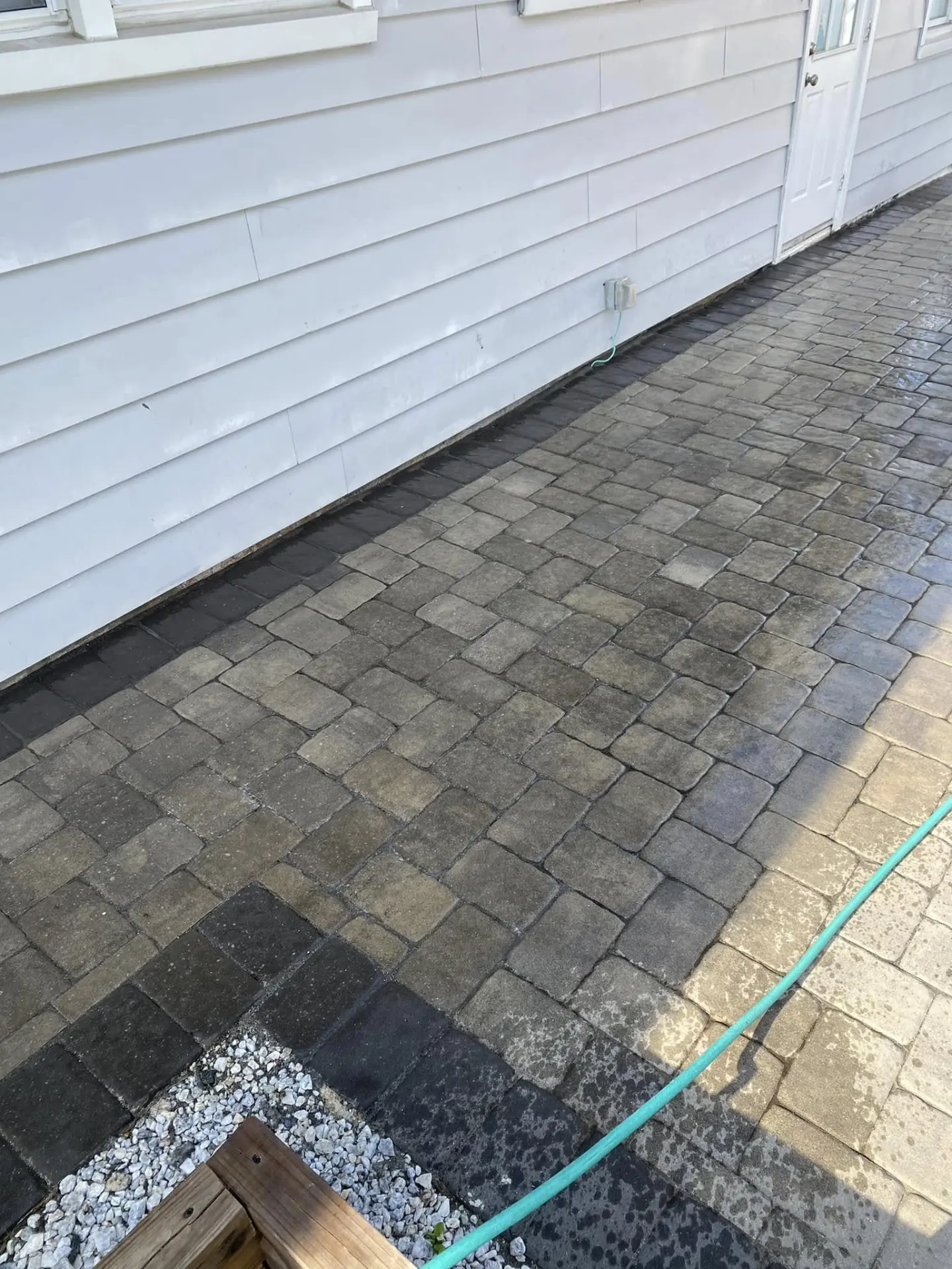 Cobblestone paver walkway running along the side of a home