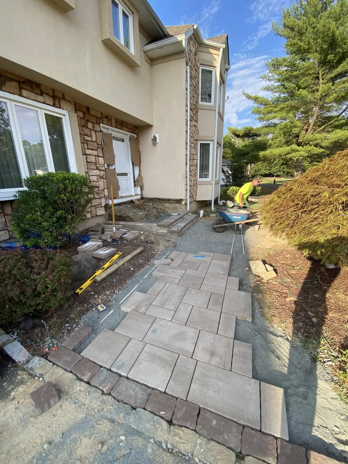 Fiorenza Landscaping crew installing a paver walkway at a front entry