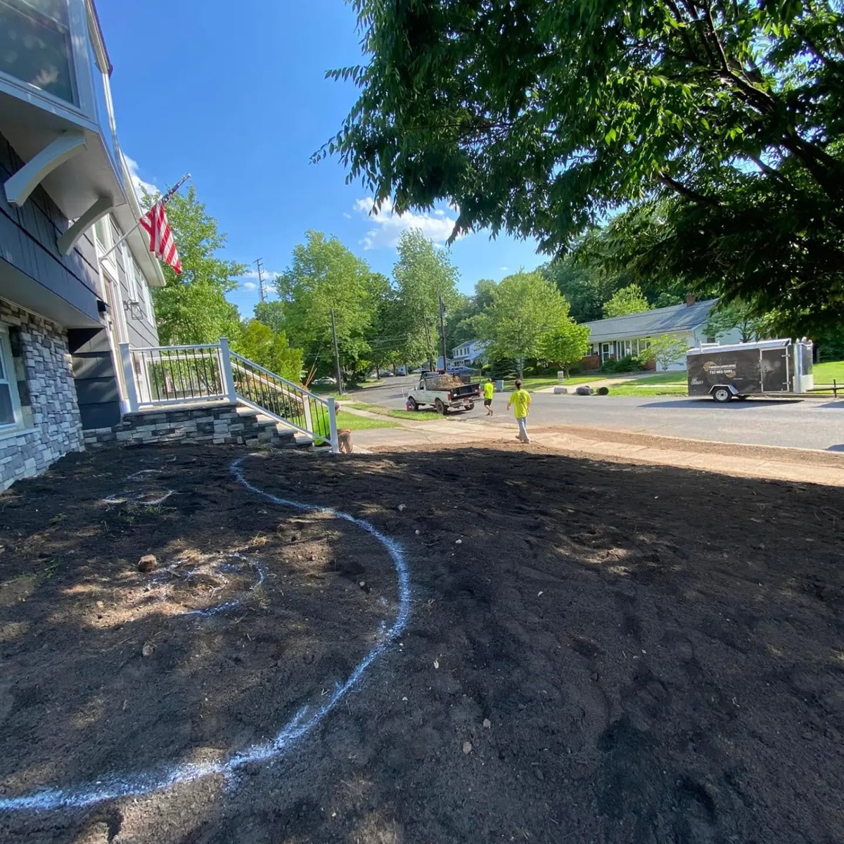 The same front yard before work, graded down to bare soil